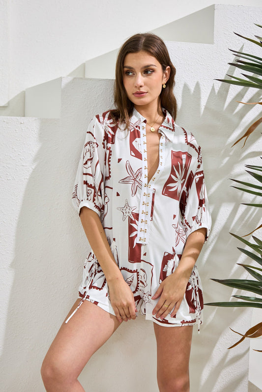 Image of a model wearing Outerwear. Productname: Heychic Mira Sea Shells Tropical Playsuit in Brown colour by brand - Heychic