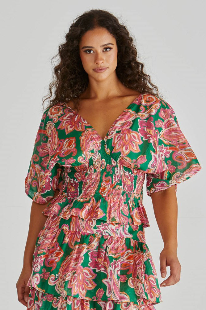 Image of a model wearing Tops. Product name - Malia Peplum Top Pink Green Paisley in Pink Green Paisley colour by brand - Sass Clothing