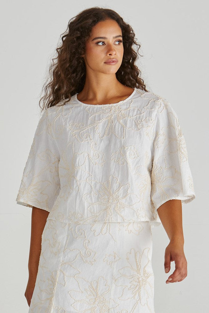 Image of a model wearing Tops. Product name - Shay Top Cream in Cream colour by brand - Sass Clothing