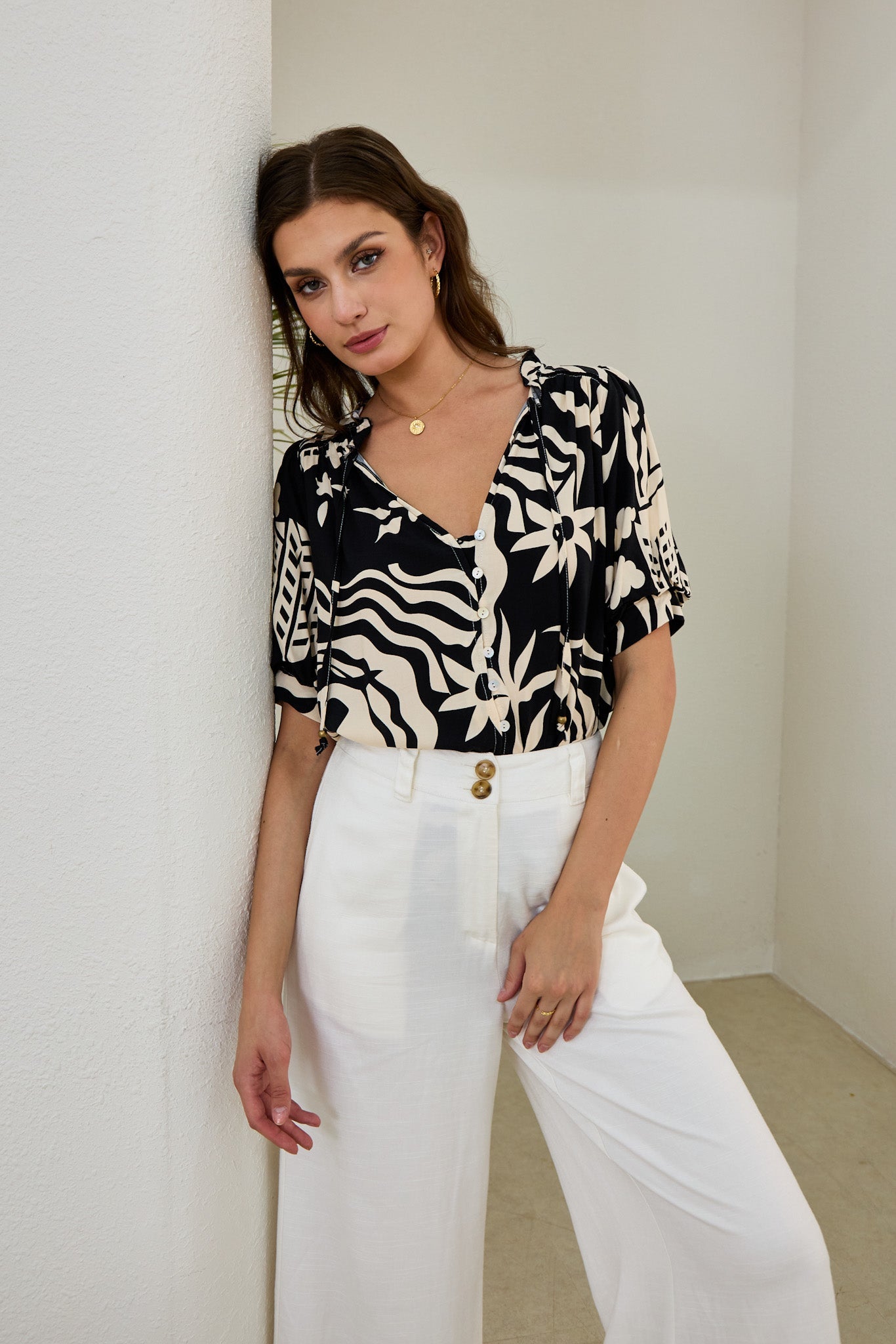 Image of a model wearing Tops. Productname: Heychic Cali Black Abstract Puff Sleeve Top in Black colour by brand - Heychic