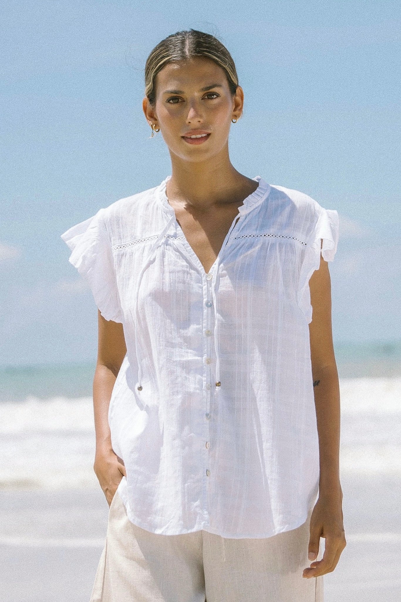 Image of a model wearing Tops. Productname: Eve White Ruffle Top in White colour by brand - Heychic