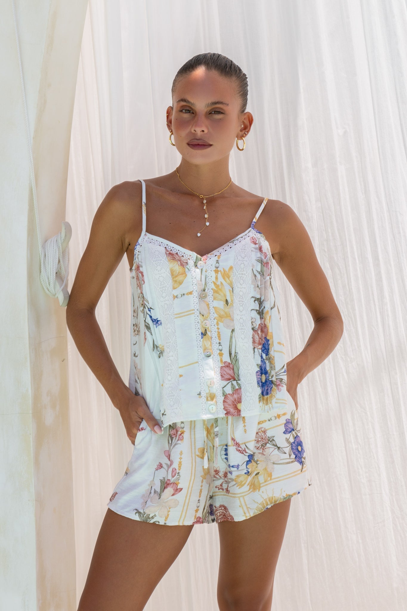 Image of a model wearing Tops. Product name - Melina Multicolour Floral Cami Top in Floral colour by brand - Heychic