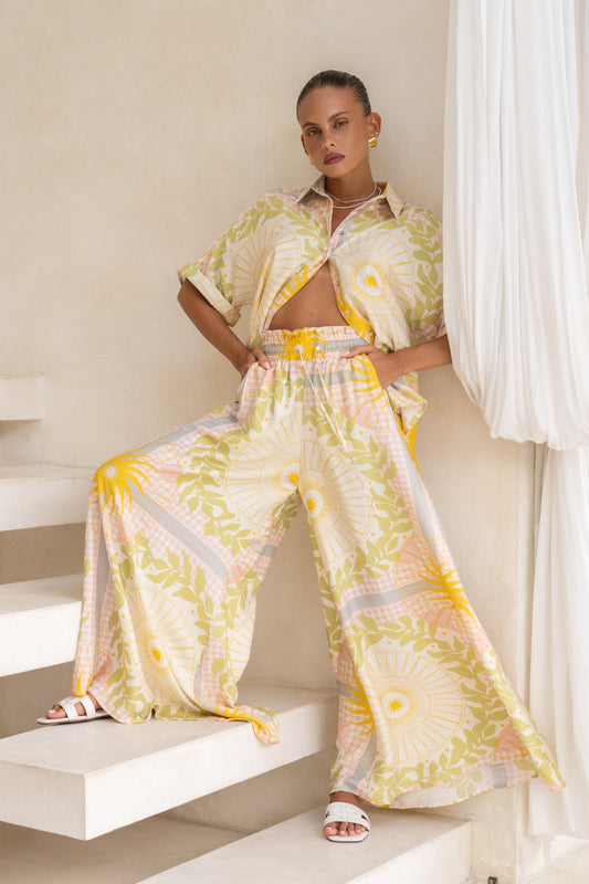 Image of a model wearing Pants. Productname: Heychic Aurea Pink Abstract Wide Leg Pants in Yellow colour by brand - Heychic