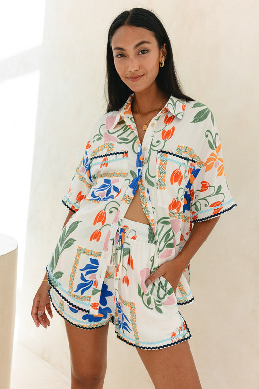 Image of a model wearing Tops. Product name - Calantha Multicolour Floral Ric Rac Shirt in Floral colour by brand - Heychic