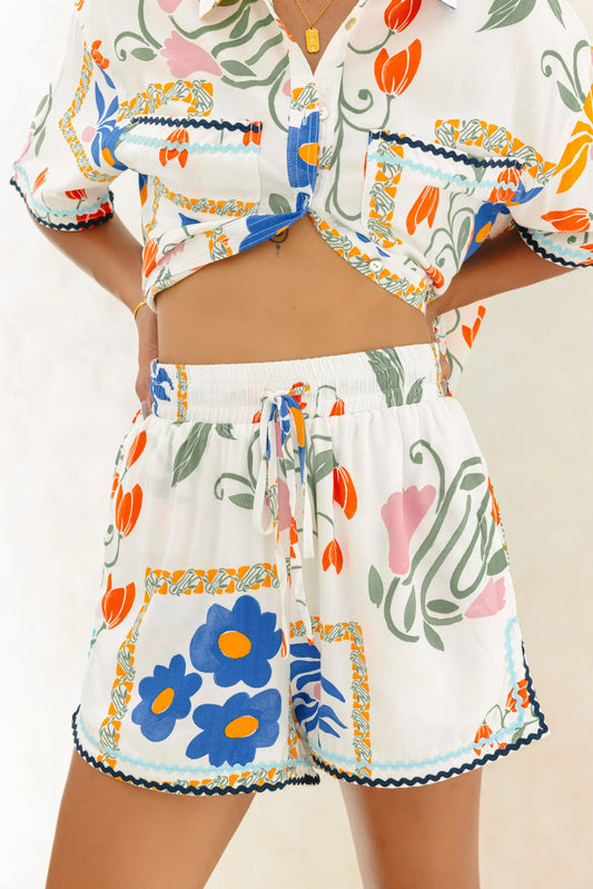 Image of a model wearing Shorts. Product name - Calantha Multicolour Floral Ric Rac Shorts in Floral colour by brand - Heychic