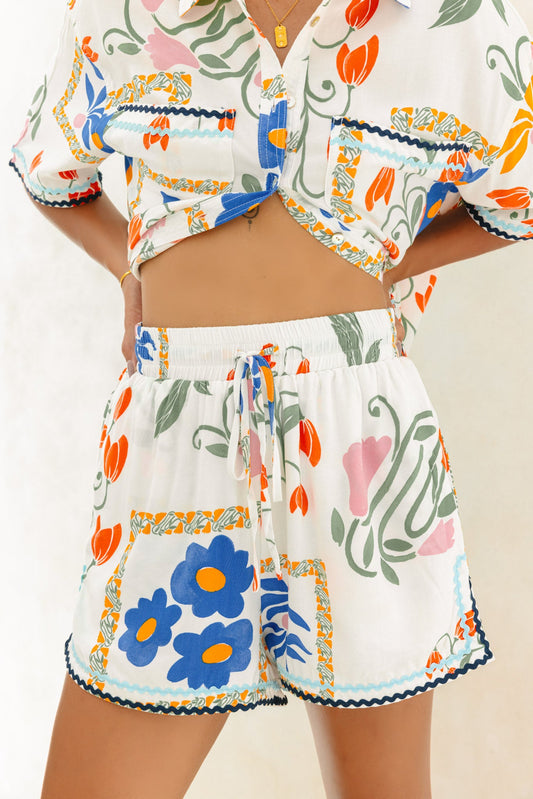 Image of a model wearing Shorts. Product name - Calantha Multicolour Floral Ric Rac Shorts in Floral colour by brand - Heychic