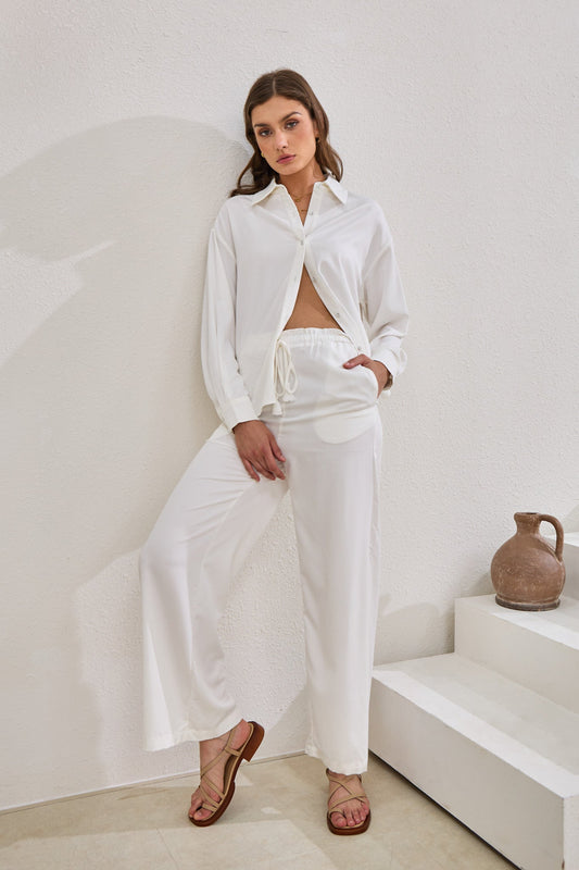 Image of a model wearing Pants. Productname: Heychic Page Cupro Pants in White colour by brand - Heychic