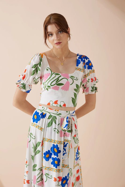 Image of a model wearing Tops. Product name - Calantha Multicolour Floral Puff Sleeve Crop Top in Floral colour by brand - Heychic