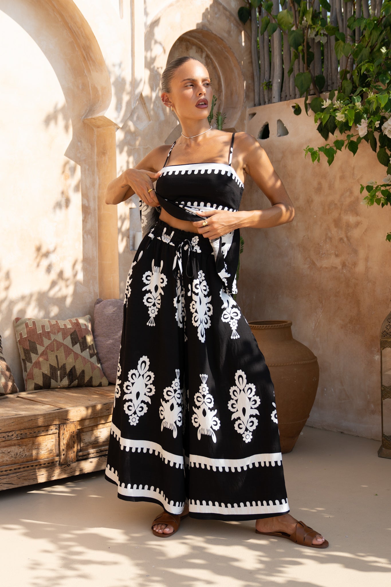 Image of a model wearing Shorts. Productname: Heychic Luna Black Abstract Wide Leg Cropped Pants in Black colour by brand - Heychic