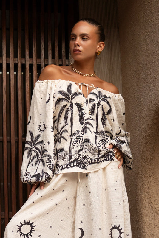 Image of a model wearing Tops. Productname: Heychic Savani Beige Black Tropical Blouse in Beige colour by brand - Heychic