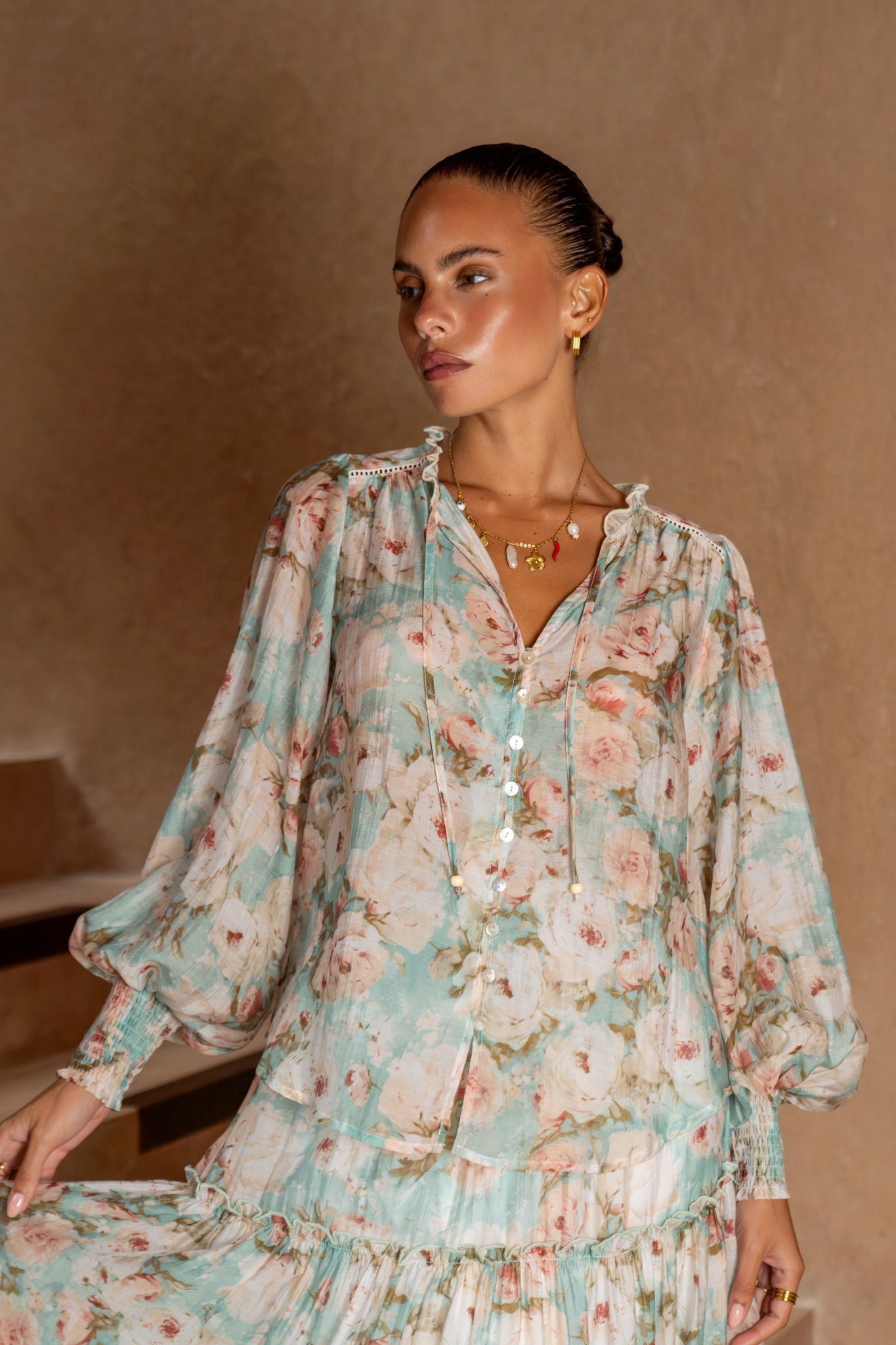 Image of a model wearing Tops. Product name - Rosalind Teal Blue Pink Floral Balloon Sleeve Blouse in Blue colour by brand - Heychic
