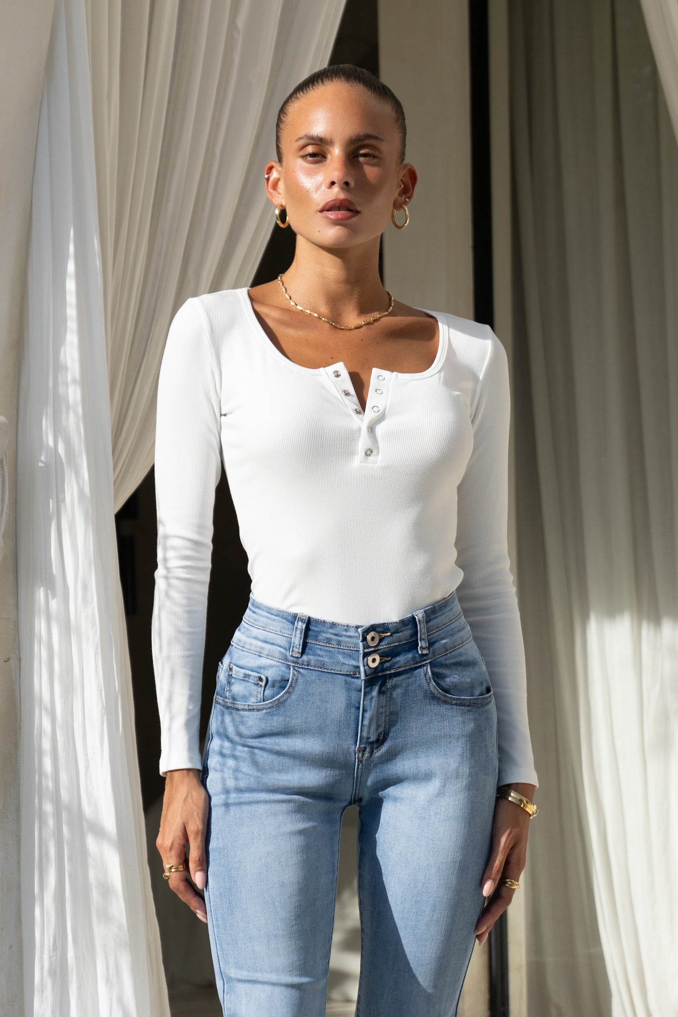 Image of a model wearing Tops. Product name - Ida Off-White Long Sleeve Top in White colour by brand - Heychic