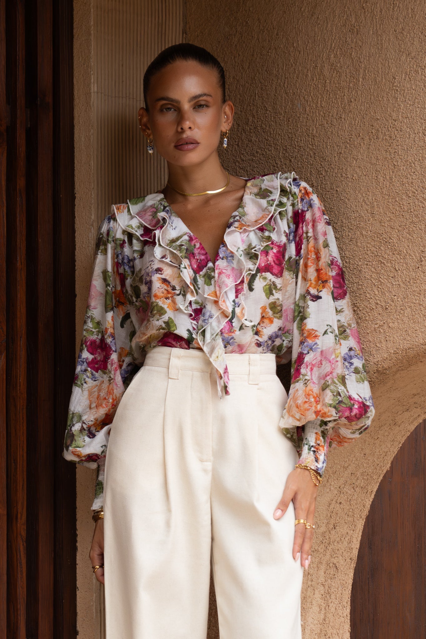 Image of a model wearing Tops. Productname: Alba Pink Floral Ruffle Long Sleeve Blouse in Floral colour by brand - Heychic