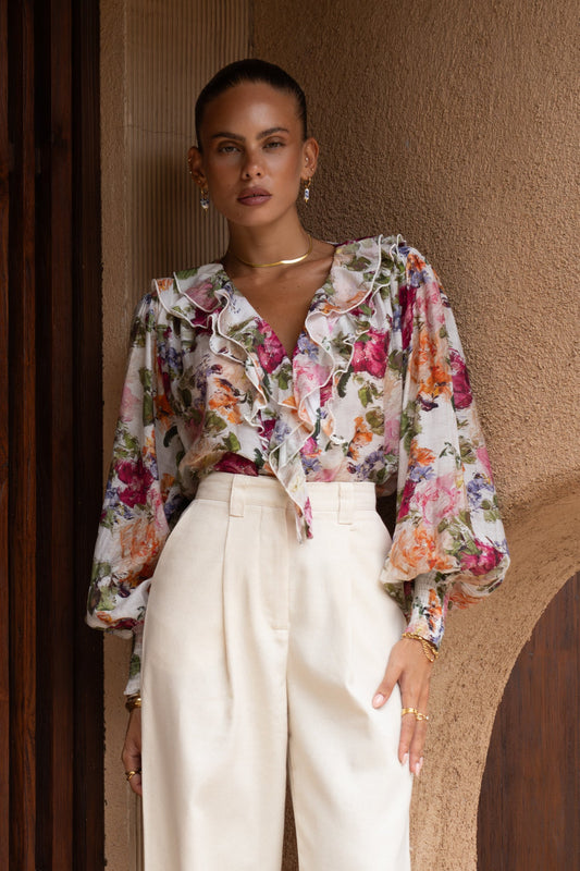 Image of a model wearing Tops. Productname: Alba Pink Floral Ruffle Long Sleeve Blouse in Floral colour by brand - Heychic