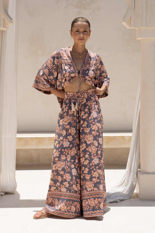 Image of a model wearing Pants. Productname: Amarante Navy Peach Floral Boho Wide Leg Pants in Navy colour by brand - HEYCHIC
