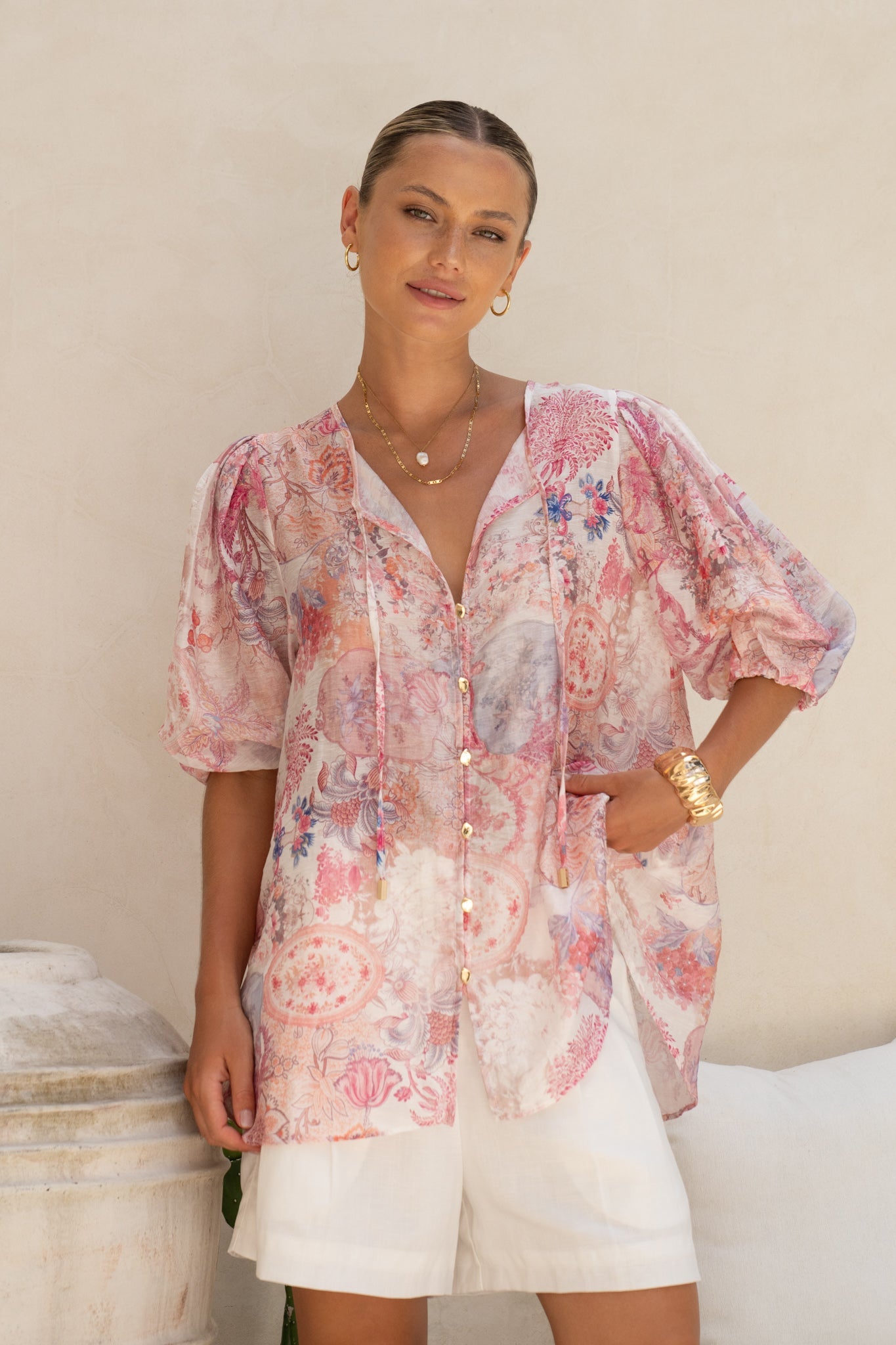 Image of a model wearing Tops. Product name - Gezelle Pink Floral Puff Sleeve Blouse in Floral colour by brand - HEYCHIC