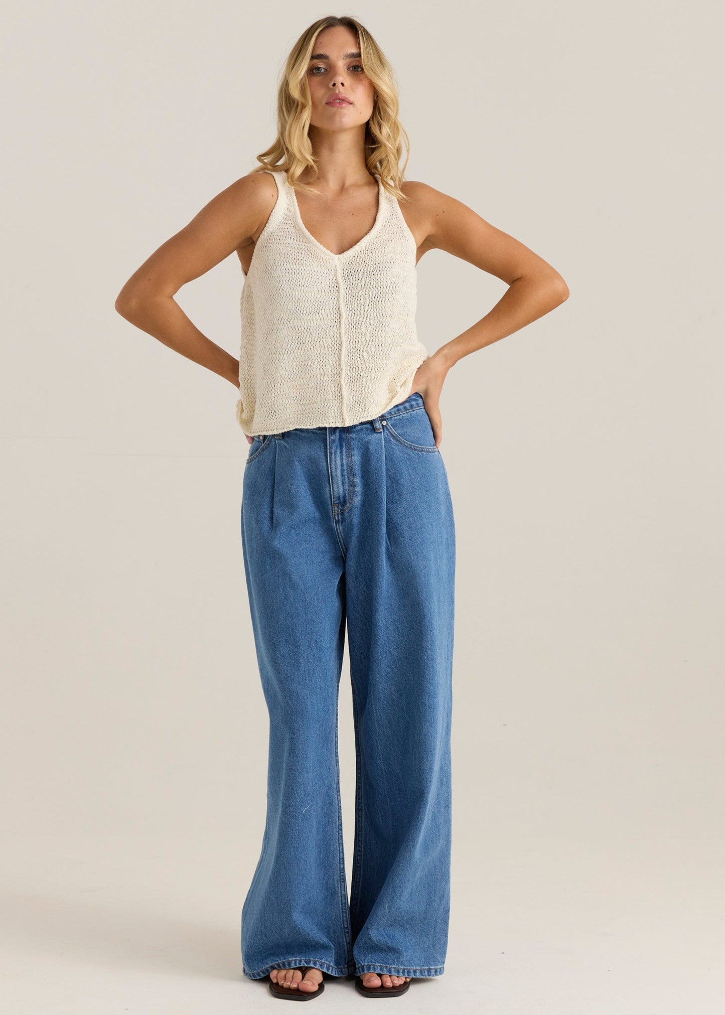 Image of a model wearing Pants. Product name - Yara Slack Pleat Jean Classic Blue Wash in Classic Blue Wash colour by brand - Sass Clothing