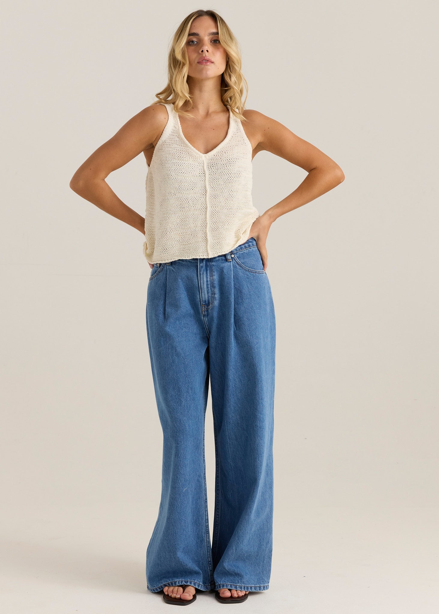 Image of a model wearing Pants. Product name - Yara Slack Pleat Jean Classic Blue Wash in Classic Blue Wash colour by brand - Sass Clothing
