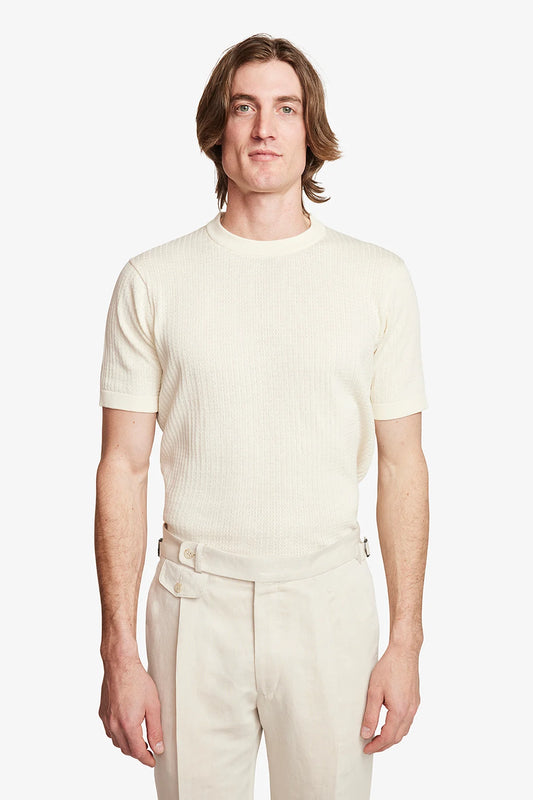 Image of a model wearing Tops. Product name - Braided Knit Tee Cream in Cream colour by brand - Anthony Squires