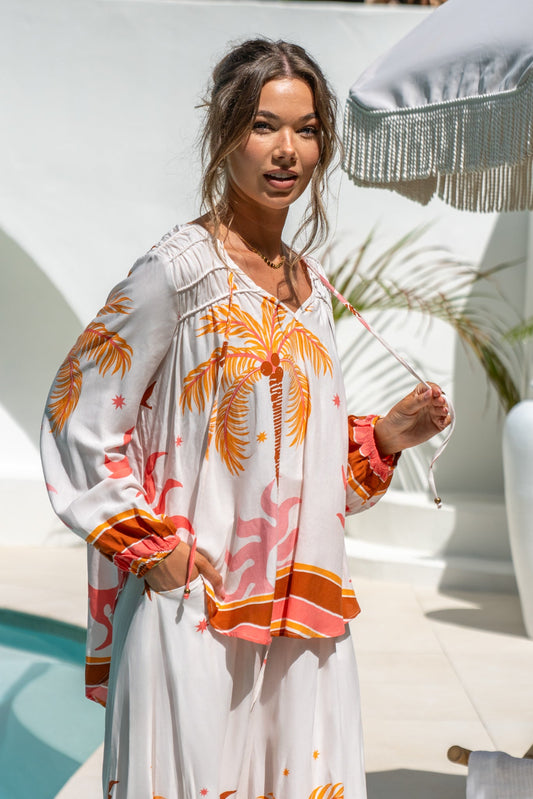 Image of a model wearing Tops. Product name - Soletta Coral Pink Tropical Long Sleeve Blouse in Pink colour by brand - Heychic
