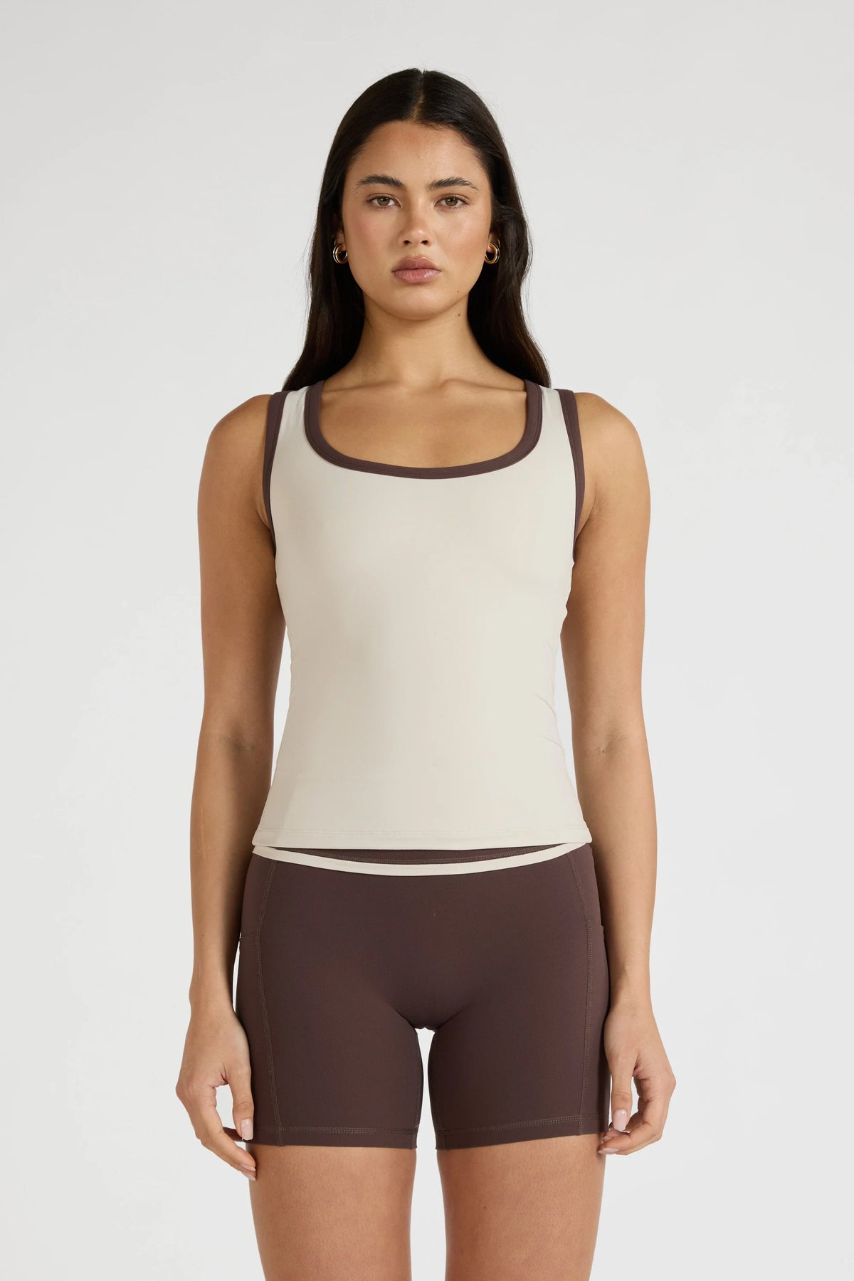 Image of a model wearing Tops. Product name - ALLFENIX CloudCore Contrast Bind Racer Tank in Stone colour by brand - All Fenix