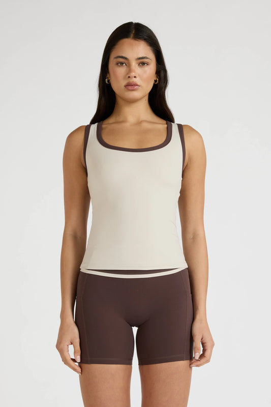 Image of a model wearing Tops. Product name - ALLFENIX CloudCore Contrast Bind Racer Tank in Stone colour by brand - All Fenix