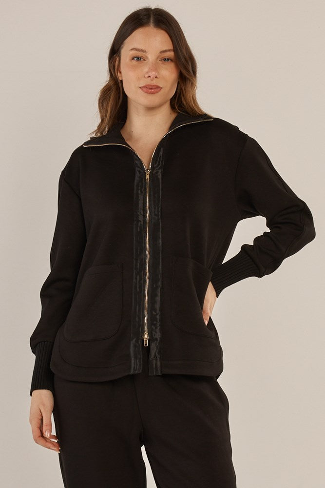 Image of a model wearing Outerwear. Product name - Sabina Sweatshirt Black in Black colour by brand - Betty Basics
