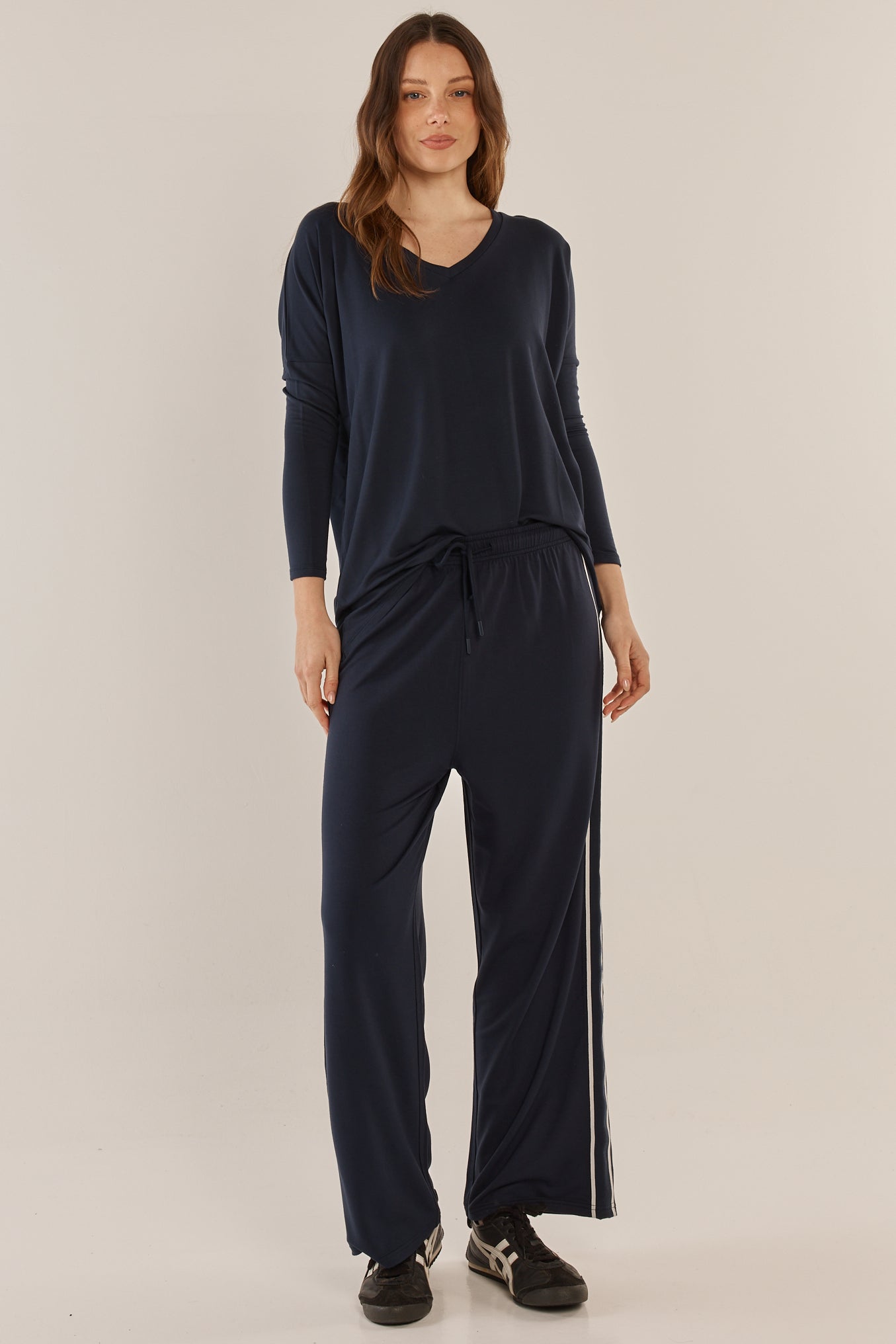 Image of a model wearing Pants. Productname: Betty Basics Evelyn Wide Leg Jogger Navy in Navy colour by brand - Betty Basics