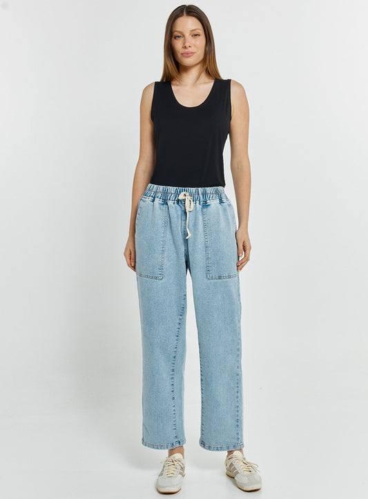 Image of a model wearing Pants. Productname: Quinn Stretch Jogger Light Blue Wash in Light Blue Wash colour by brand - Betty Basics