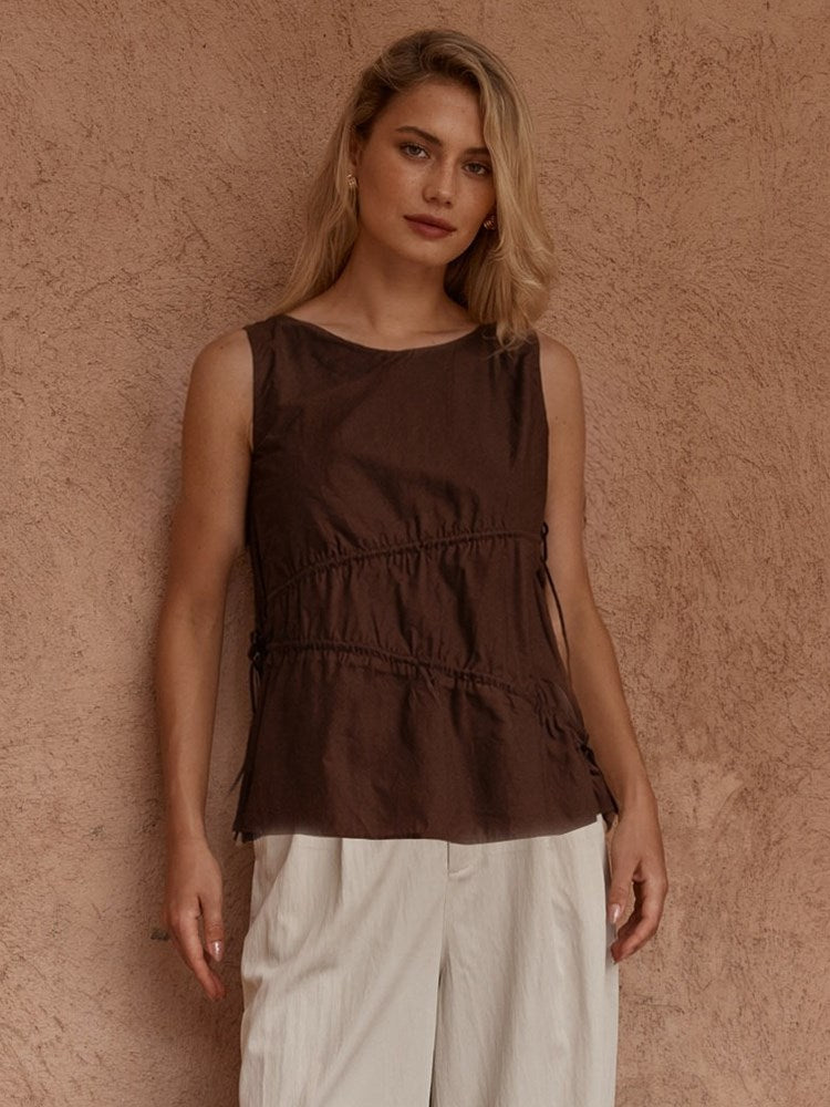 Image of a model wearing Tops. Product name - Elin Gathered Tie Top in Chocolate colour by brand - Sass Clothing