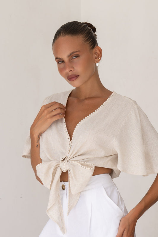 Image of a model wearing Tops. Productname: Heychic Frankie Broderie Tie Front Crop Top in Beige colour by brand - Heychic