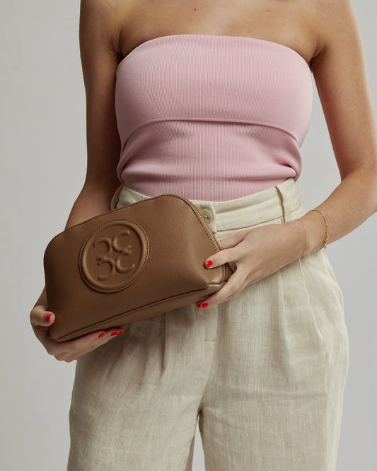 Image of a model wearing Tops. Productname: Colette Caramel Rita Zip Top Cosmetic Case in Caramel colour by brand - Colette