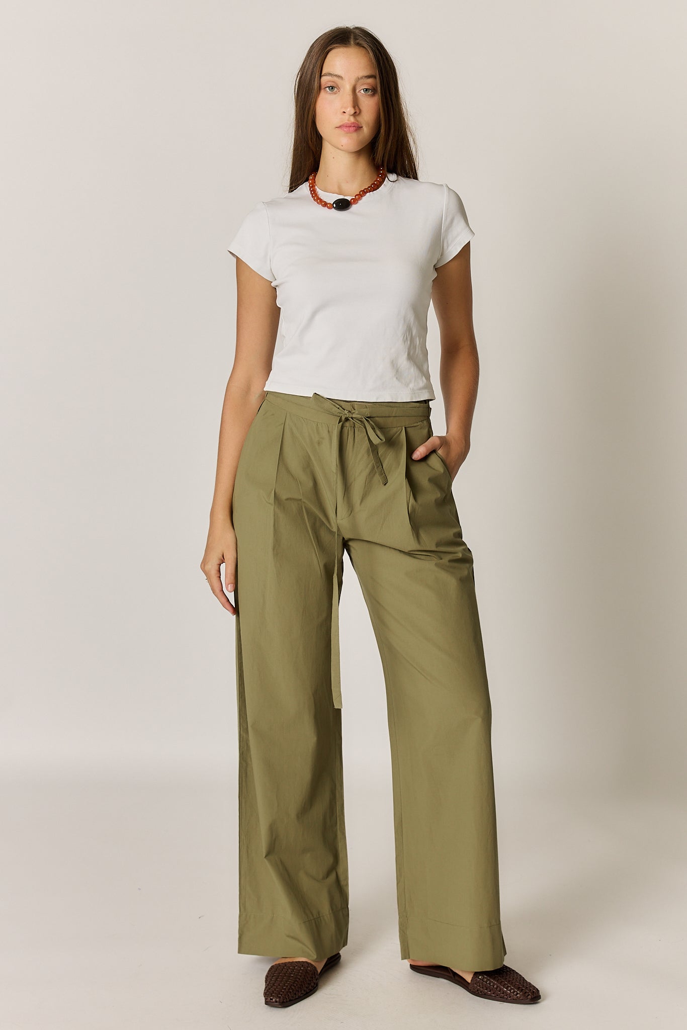 Image of a model wearing Pants. Product name - Giliann Floyd Tie Pant Olive in Olive colour by brand - Giliann