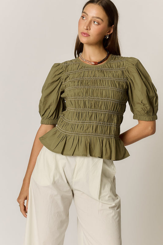 Image of a model wearing Tops. Product name - Giliann Pyke Shirred Top Olive in Red colour by brand - Giliann
