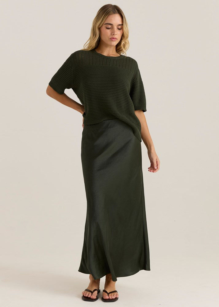 Image of a model wearing Skirts. Product name - Jasper Slip Skirt Olive in Olive colour by brand - Sass Clothing
