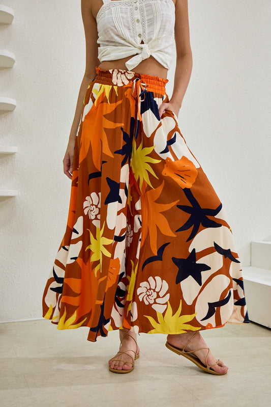 Image of a model wearing Pants. Productname: Heychic Esmeralda Abstract Wide Leg Cropped Pants in Orange colour by brand - Heychic