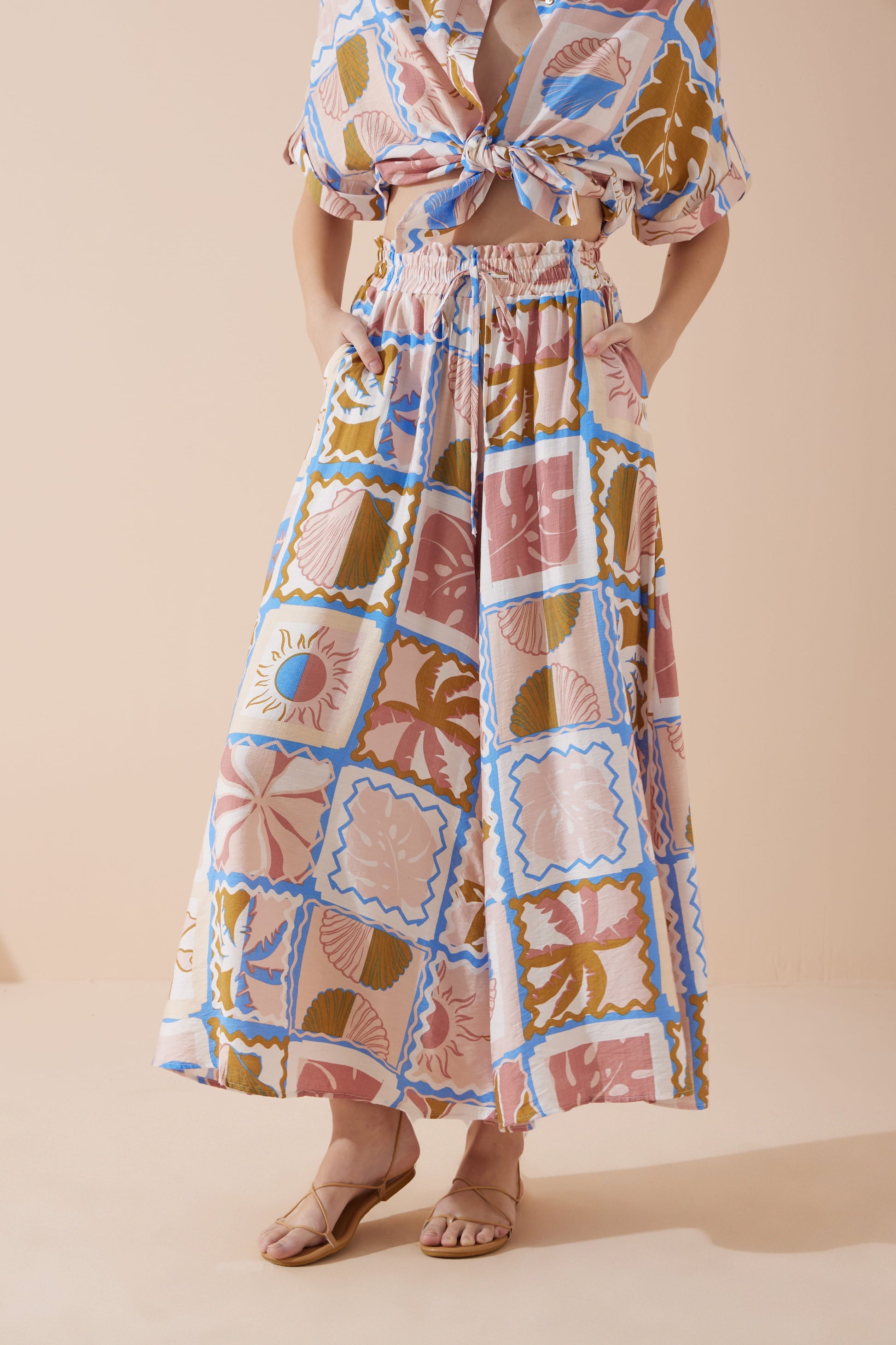 Image of a model wearing Pants. Productname: Heychic Ismerie Tropical Wide Leg Cropped Pants in Pink colour by brand - Heychic