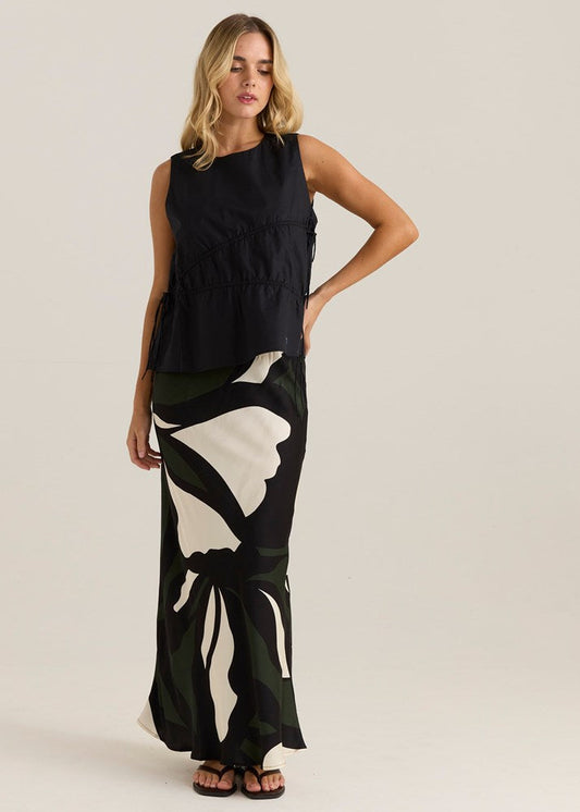 Image of a model wearing Skirts. Product name - Tarni Satin Slip Skirt Iris Abstract Print in Iris Abstract Print colour by brand - Sass Clothing