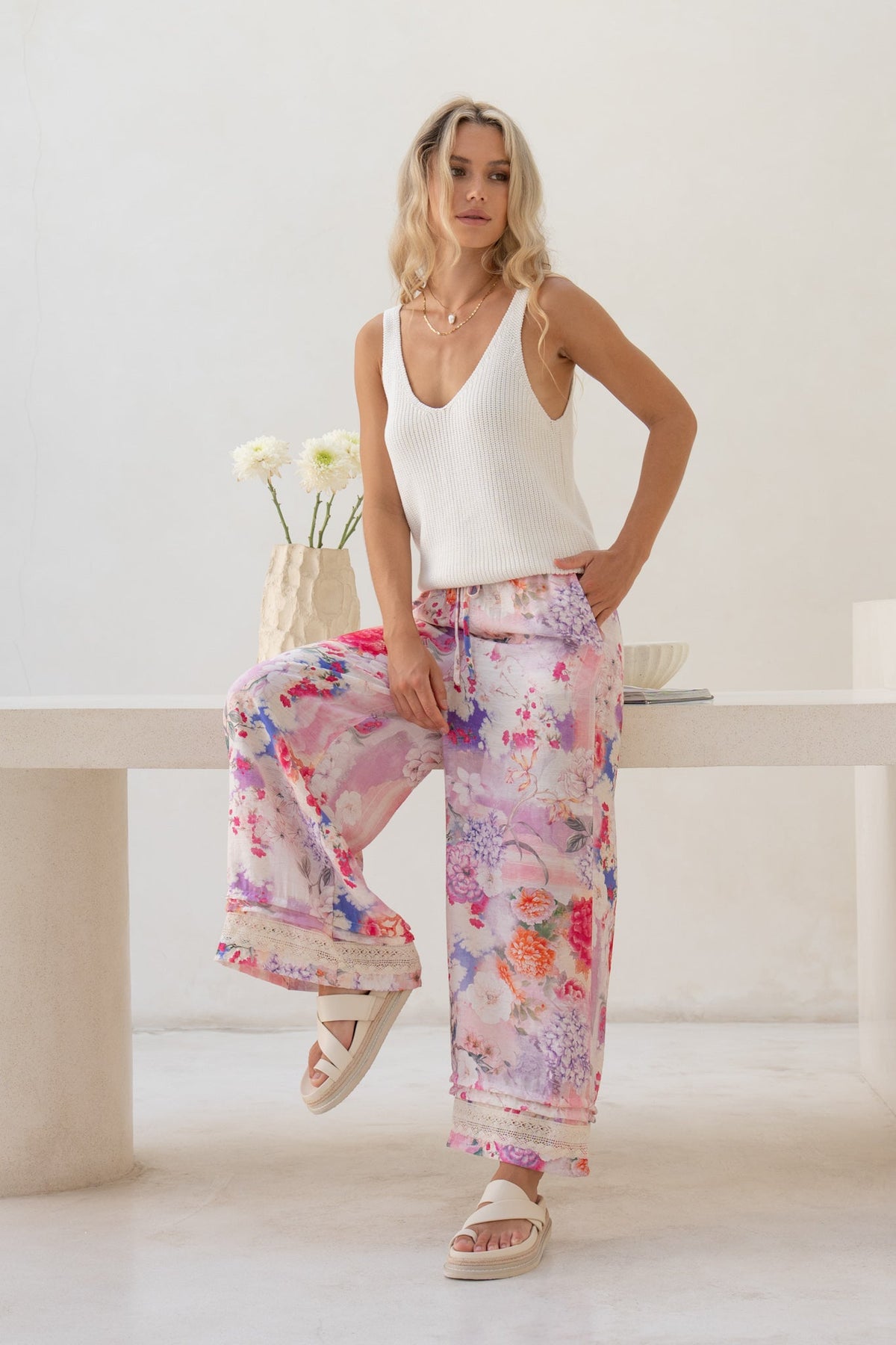 Image of a model wearing Pants. Product name - Elani Pink Floral Pants in Floral colour by brand - HEYCHIC