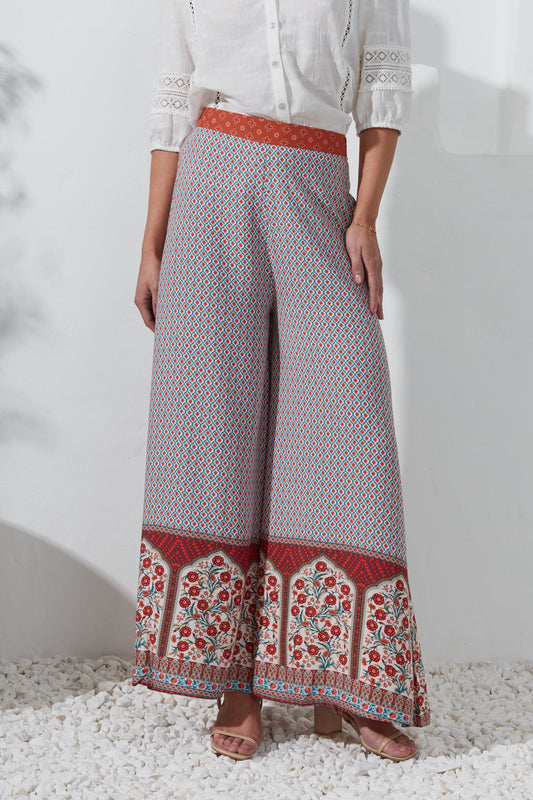 Image of a model wearing Pants. Productname: Heychic Petunia Red Floral Boho Wide Leg Pants in Red colour by brand - Heychic