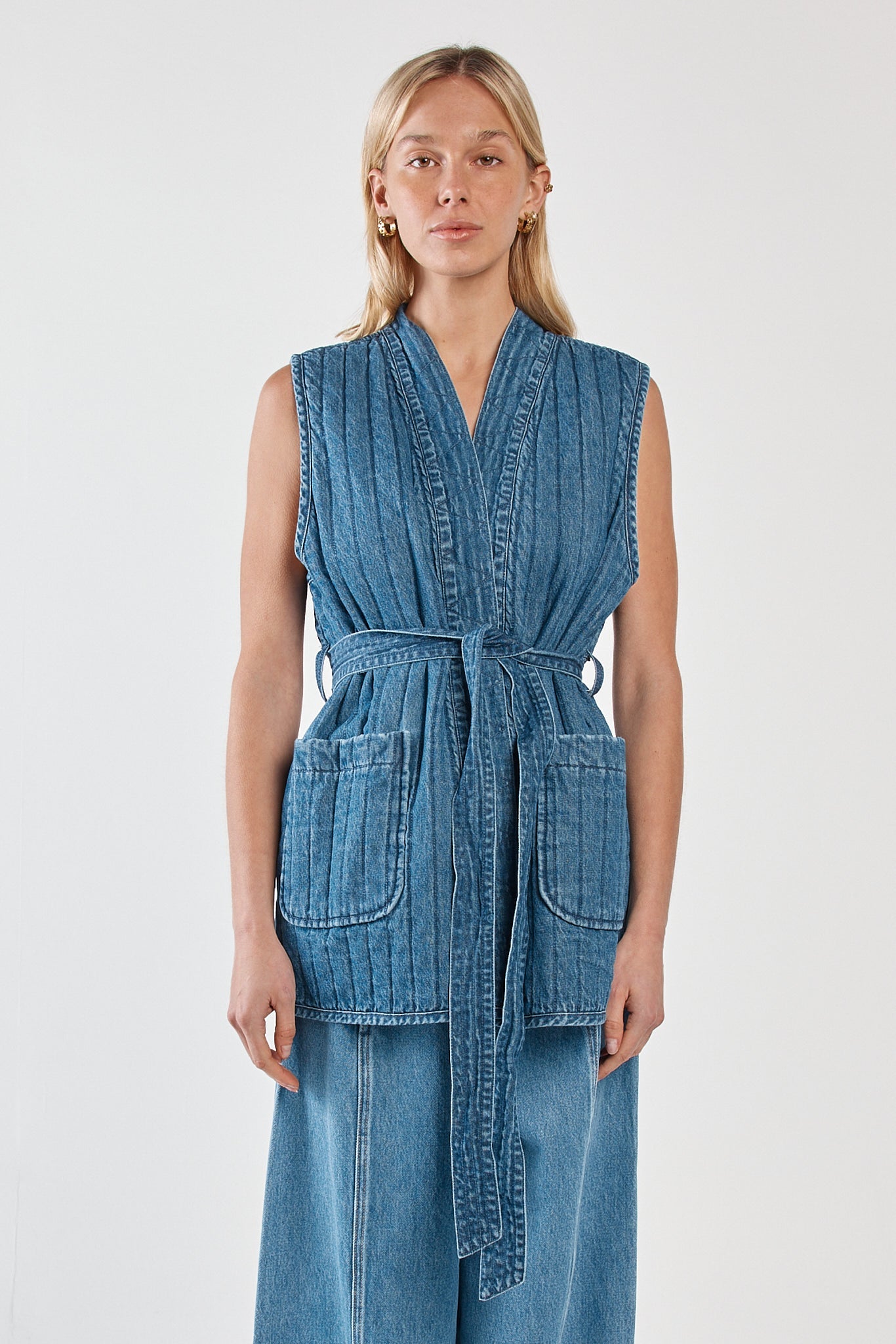 Image of a model wearing Tops. Product name - Pepa Quilted Denim Vest Classic Blue in Classic Blue colour by brand - Sass Clothing
