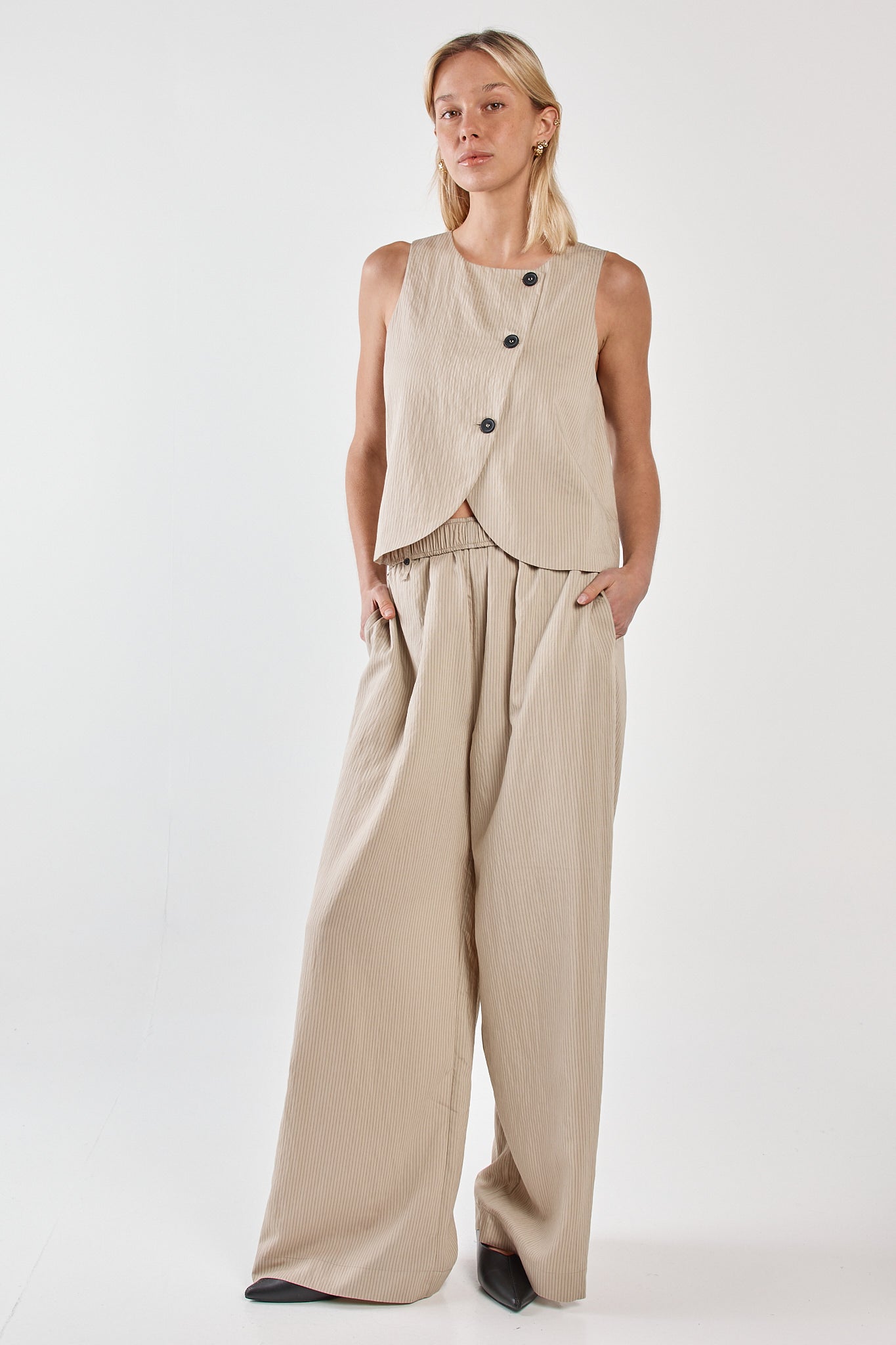 Image of a model wearing Pants. Product name - Renee Paper Bag Pant Beige Black Stripe in Beige Black Stripe colour by brand - Sass Clothing