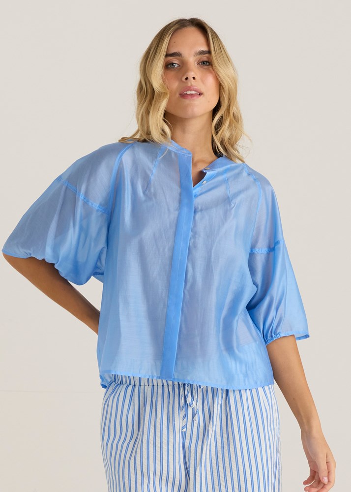 Image of a model wearing Tops. Product name - Wilder Seam Blouse Cornflower in Cornflower colour by brand - Sass Clothing