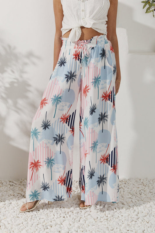 Image of a model wearing Pants. Productname: Heychic Maluhia Tropical Wide Leg Pants in Blue colour by brand - Heychic