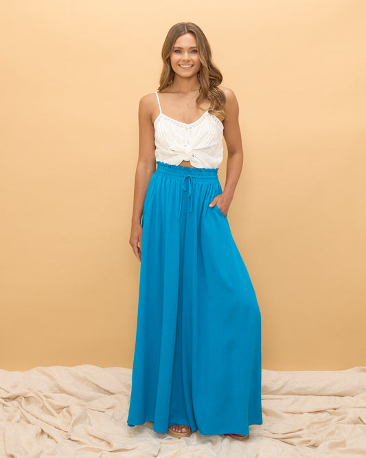 Image of a model wearing Pants. Productname: HEYCHIC Sol Wide Leg Pants in Blue colour by brand - HEYCHIC