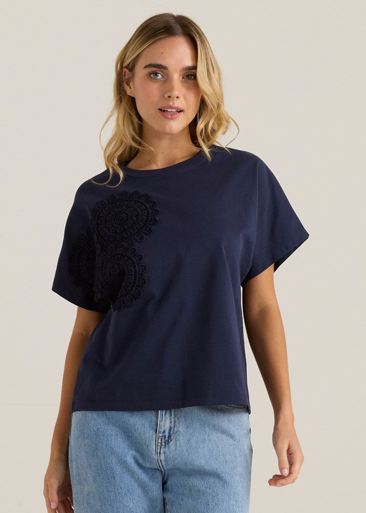 Image of a model wearing Tops. Product name - Mira Crochet Tee Navy in Navy colour by brand - Sass Clothing