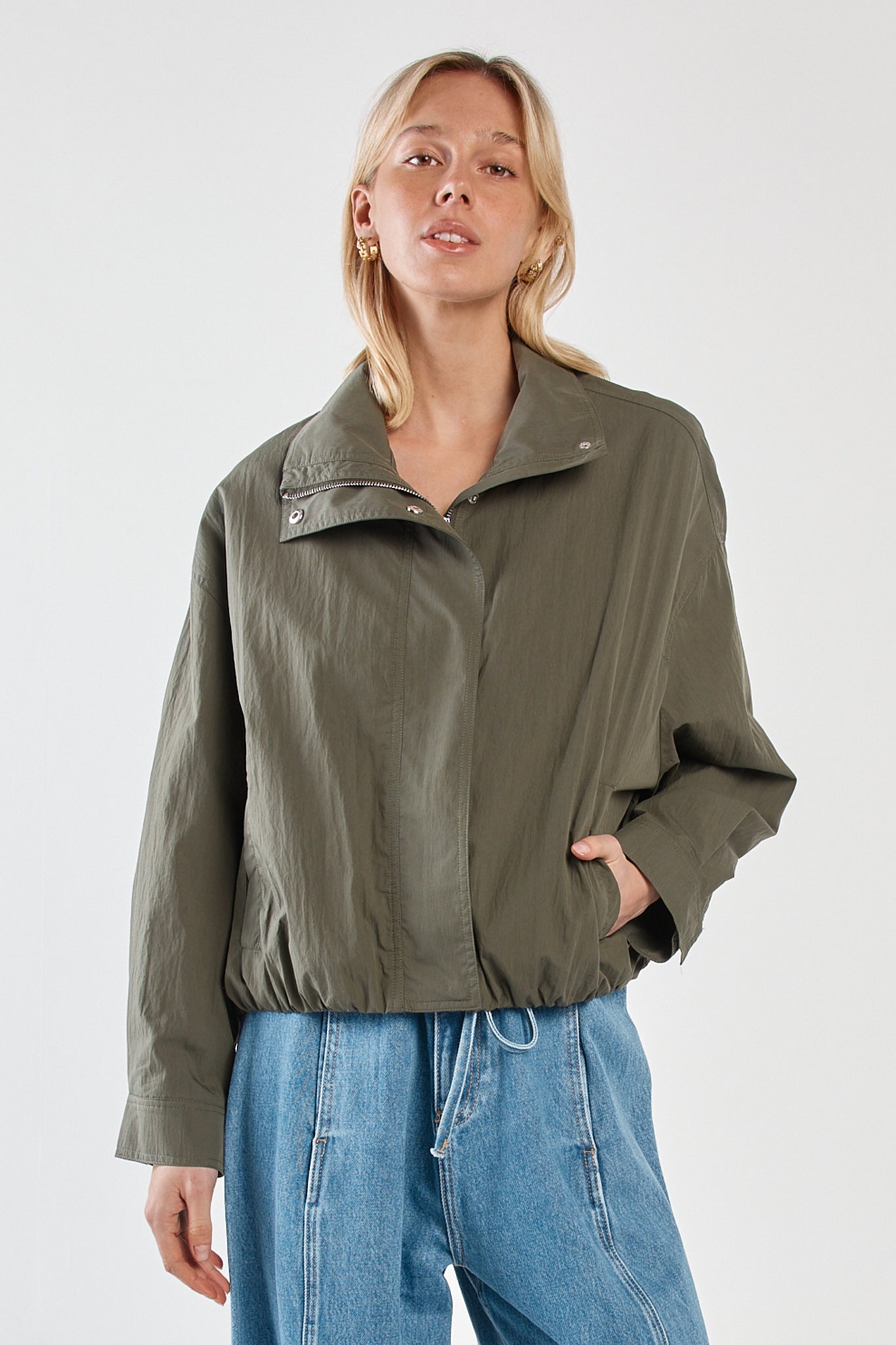 Image of a model wearing Outerwear. Product name - Murphy Bomber Jacket Olive in Olive colour by brand - Sass Clothing