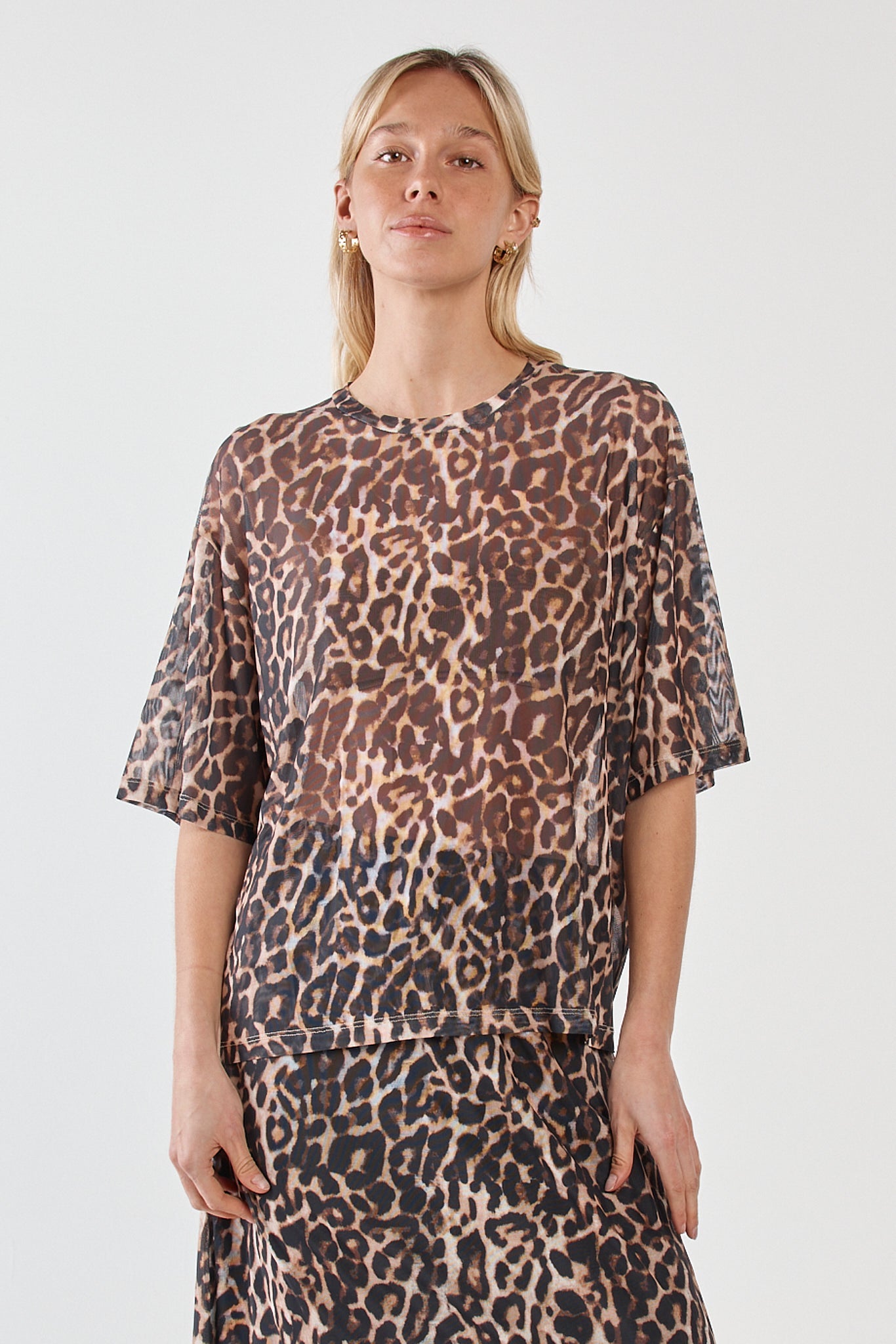 Image of a model wearing Tops. Product name - Oxley Print Mesh Tee Animal in Animal colour by brand - Sass Clothing