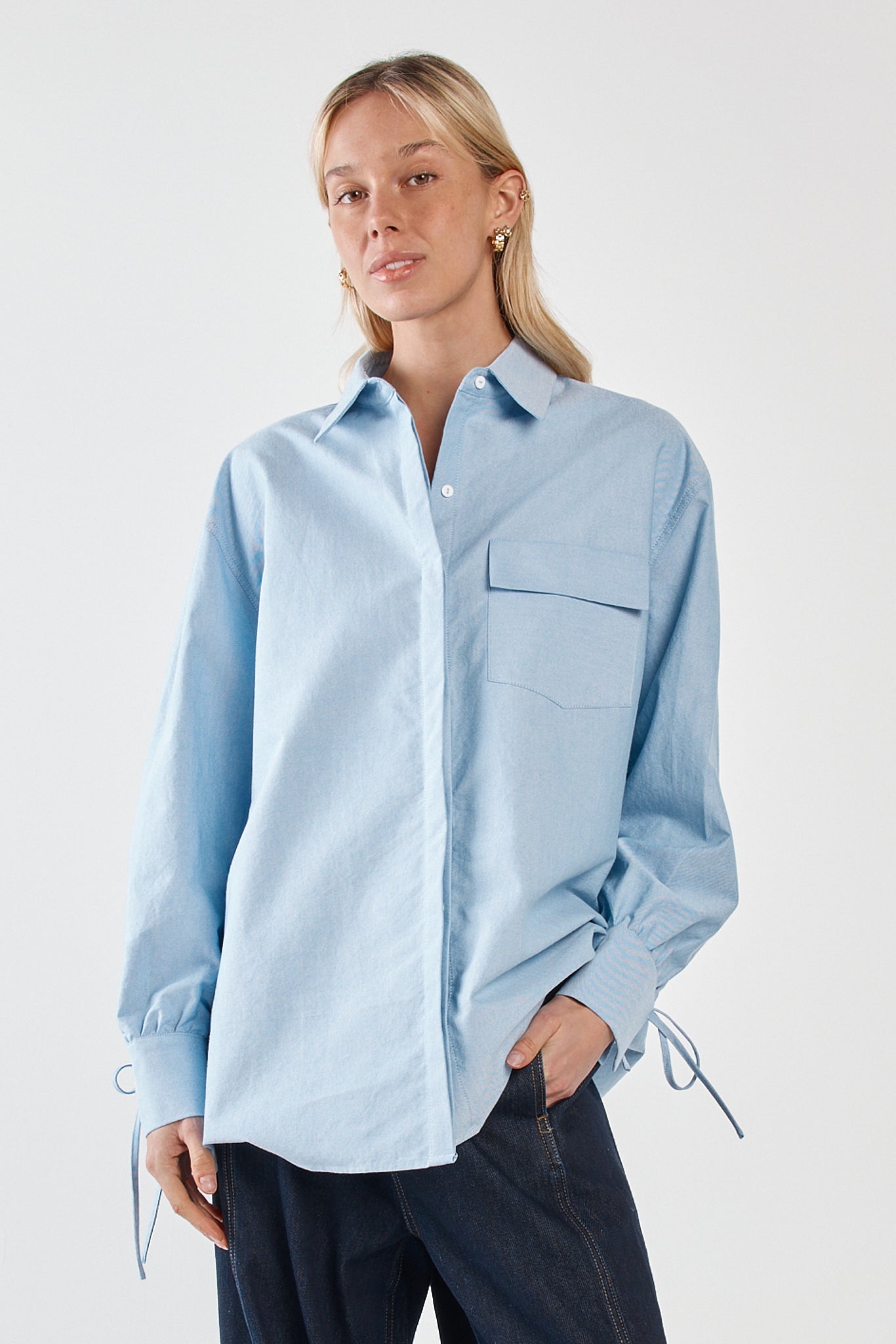 Image of a model wearing Tops. Product name - Sonora Oxford Shirt Blue in Blue colour by brand - Sass Clothing