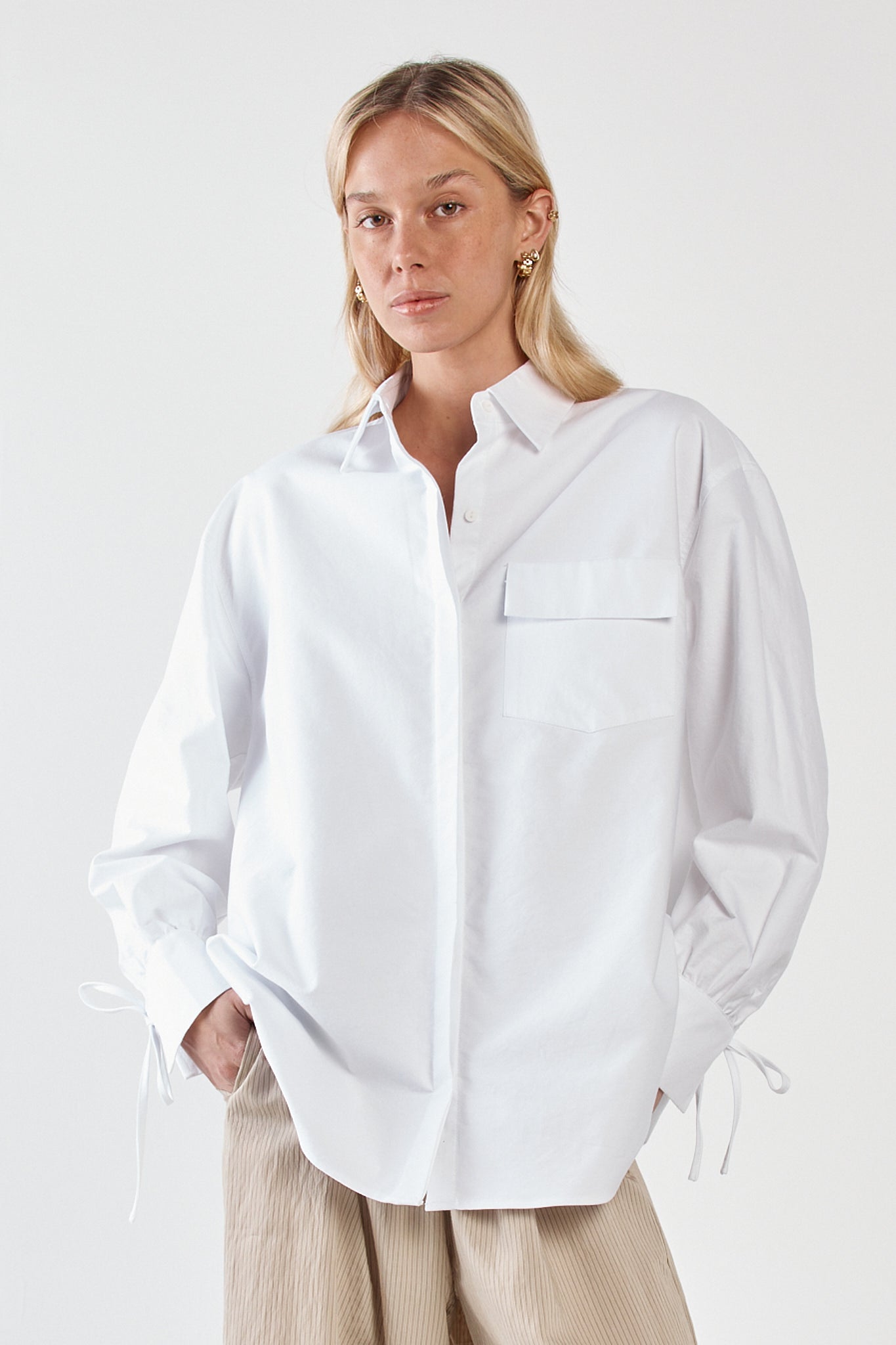 Image of a model wearing Tops. Product name - Sonora Oxford Shirt White in White colour by brand - Sass Clothing